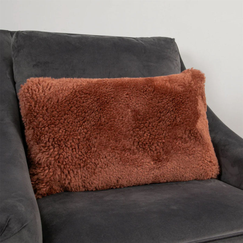 Talia Bolster Sheepskin Cushion in Coral Orange
